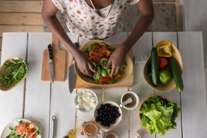 Young African Woman Cooking Salad