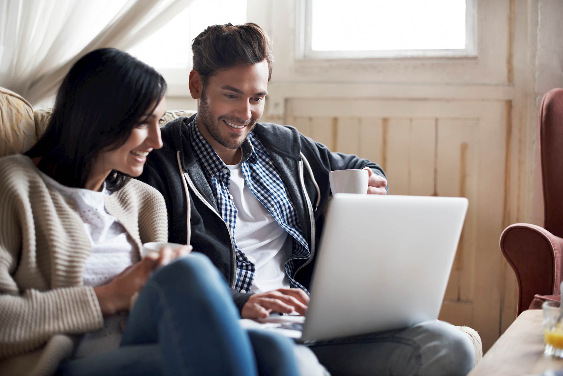Two people looking at a laptop