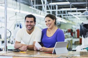 Hispanic small business owners, dry cleaner paying bills