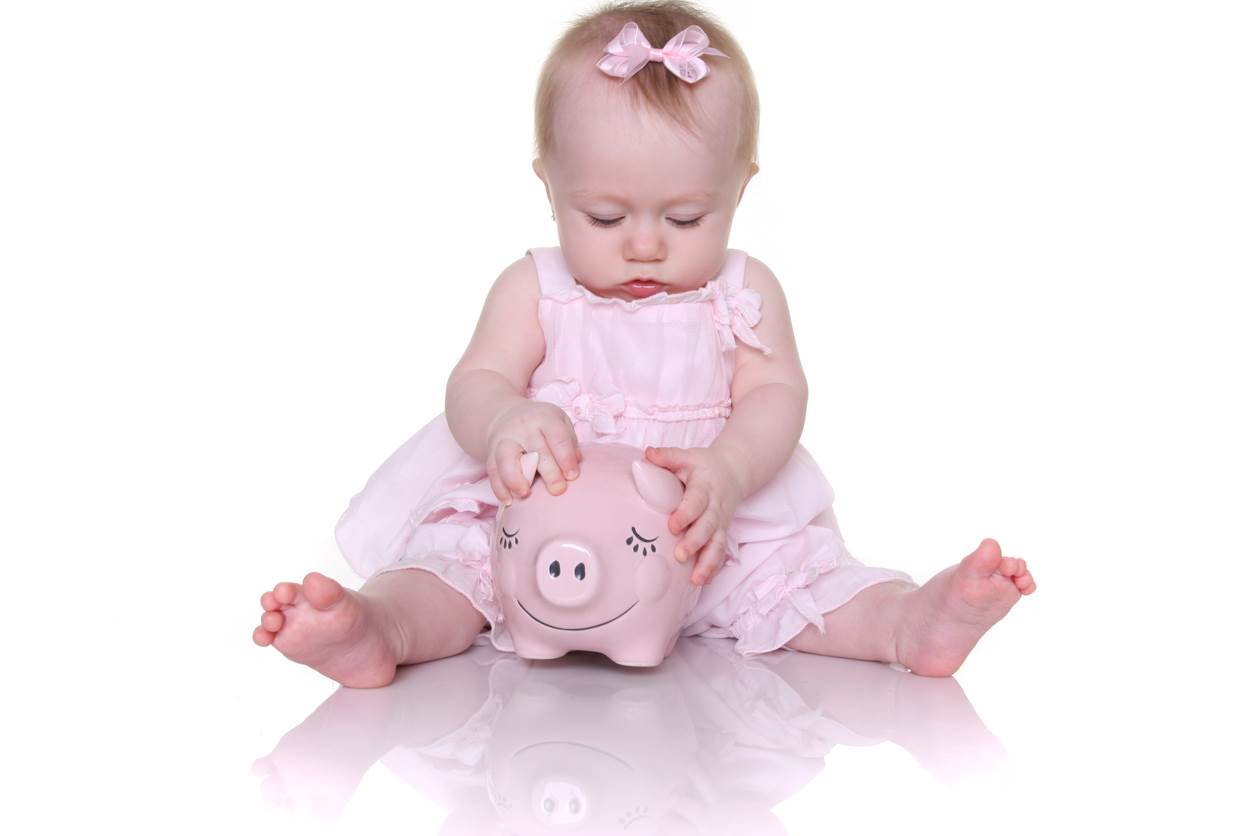 Baby girl with a piggy bank