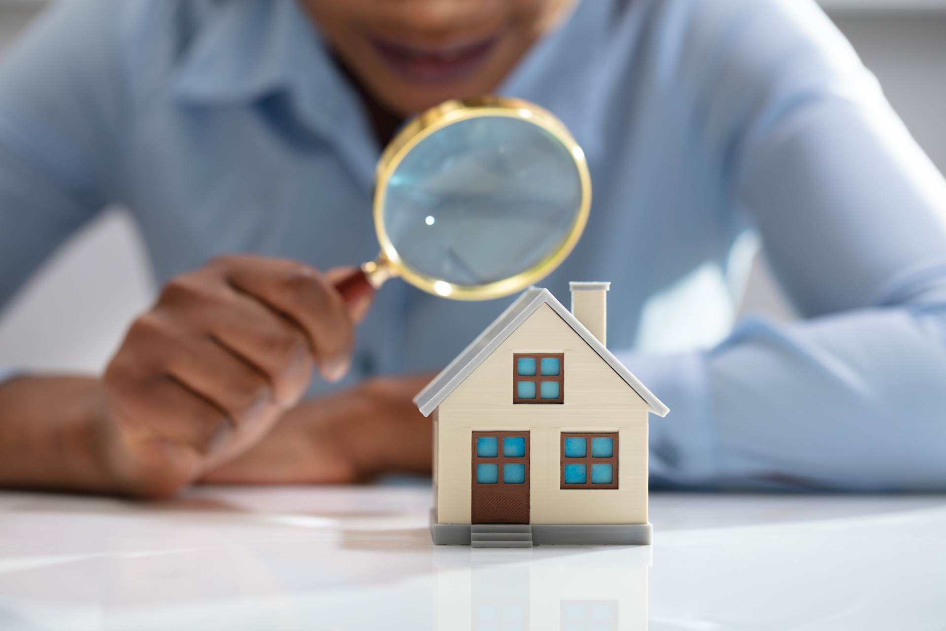 Woman looking at a small house