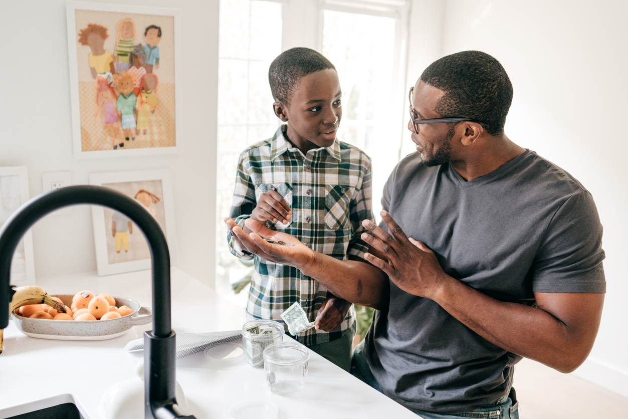 A father teaches his son about money