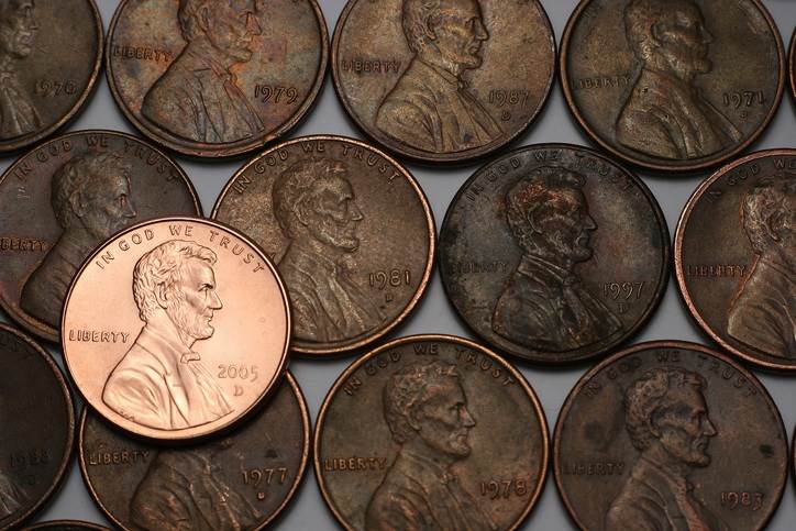 Shiny penny on bed of old pennies