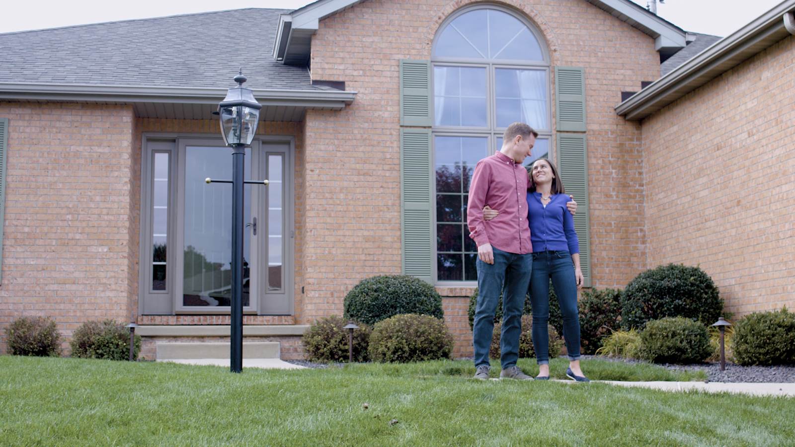 couple in front of new home