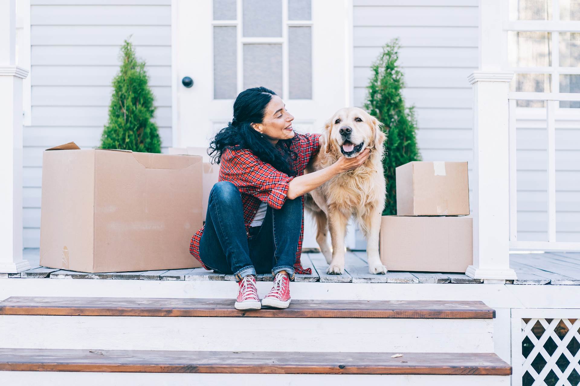 Woman at new home with a golden retriever dog
