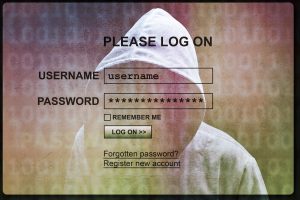 Computer hacker silhouette of hooded man with internet login screen concept for security, phishing and hacking network account username and password