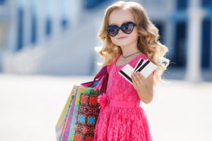little girl shopping with credit cards