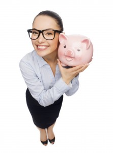 saving; how to save - smiling businesswoman in eyeglasses with piggy bank