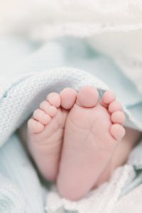 baby feet wrapped in blue blanket