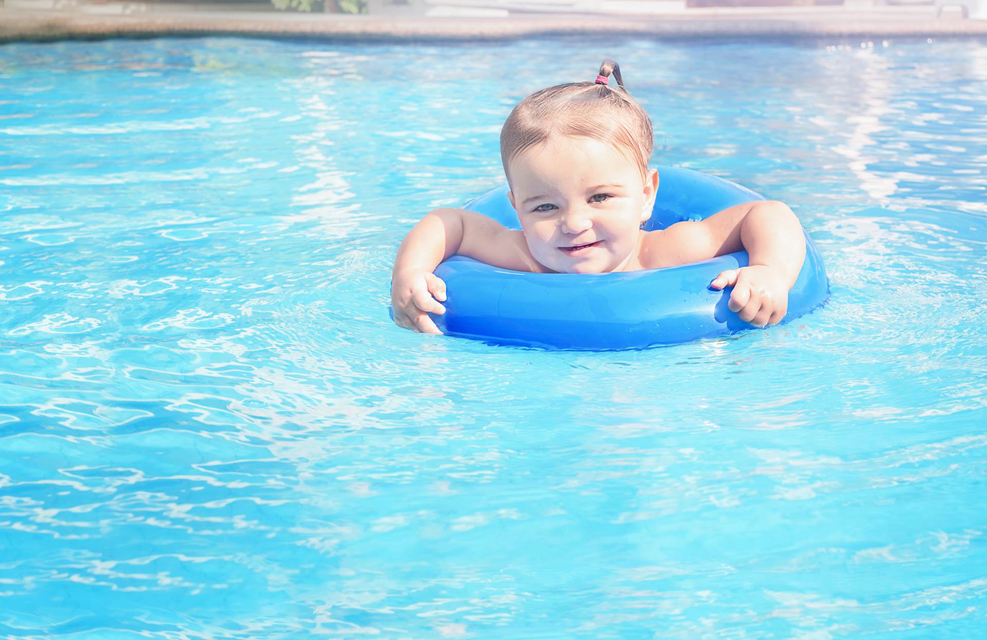 Small child playing in a pool