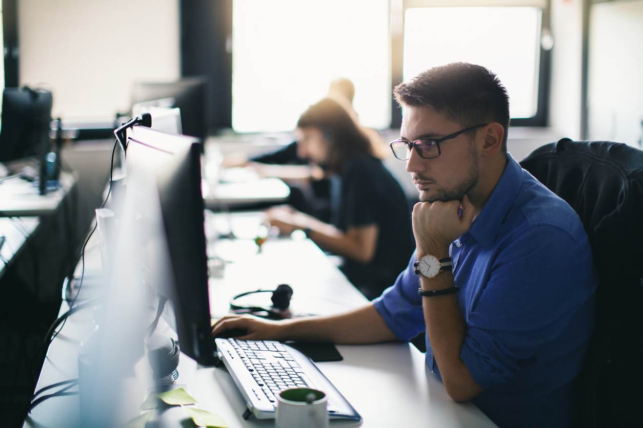 A man working diligently at a computer