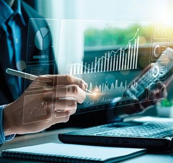 person working on a computer with calculator