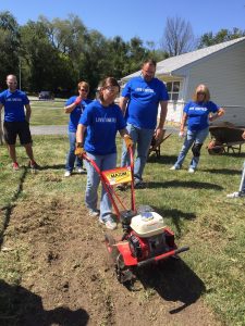 Missy Searcy pushes tiller through hard ground.