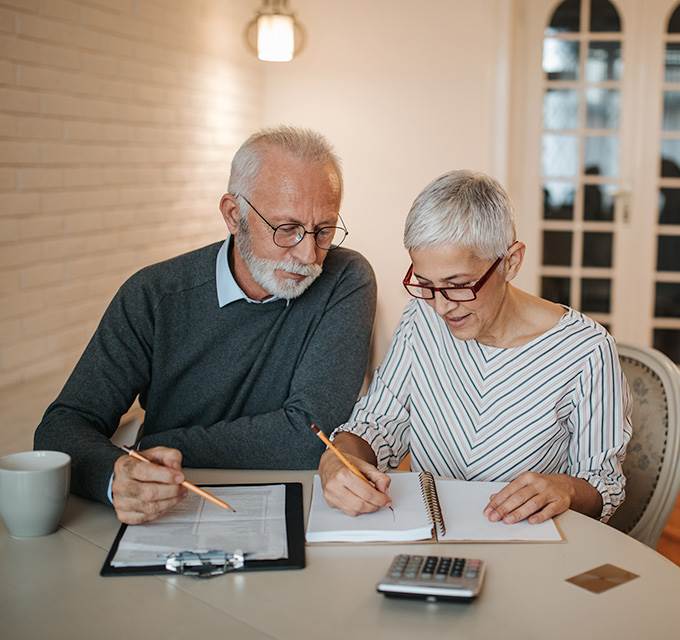 Elderly couple looking over documents