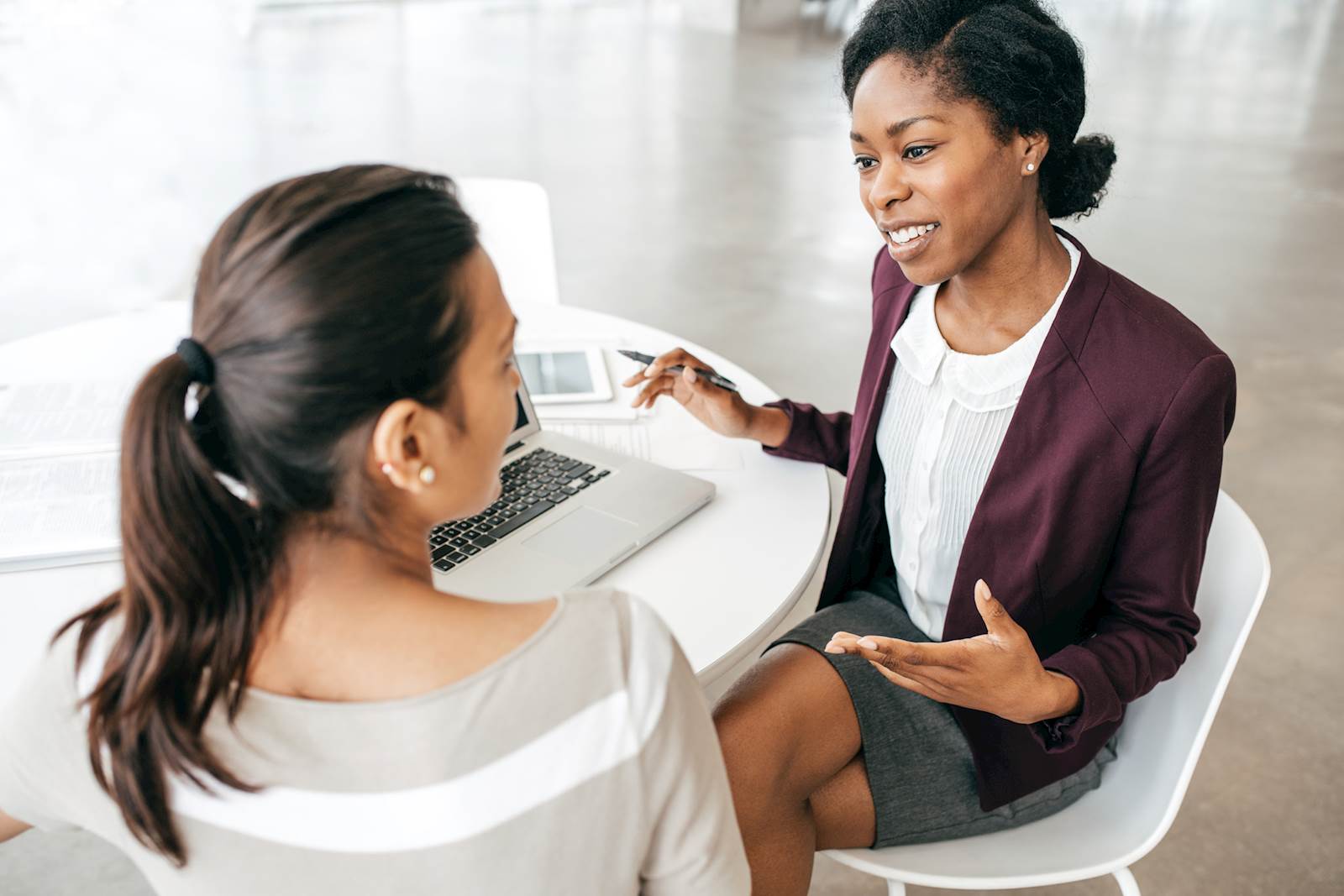 2 women talking in an office setting