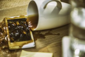 Coffee spilling over smartphone
